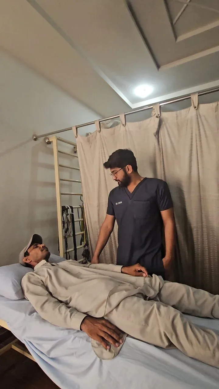 Physiotherapist providing personalized home physiotherapy to an elderly patient